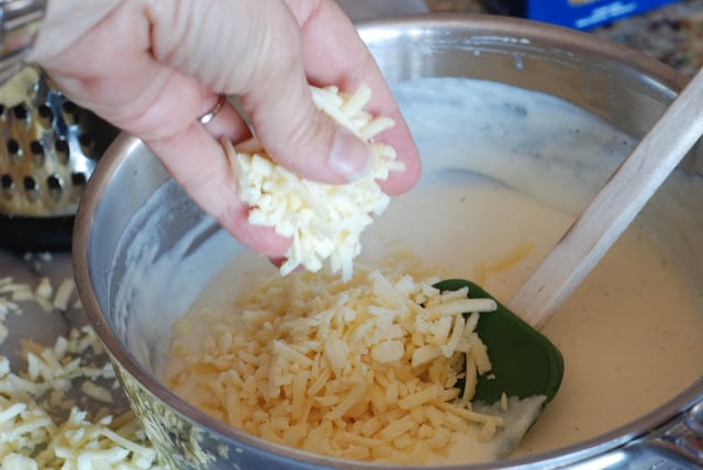 cheese being added to cream mixture