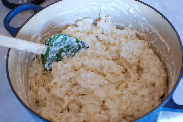 cream mixture stirred into macaroni in blue pot