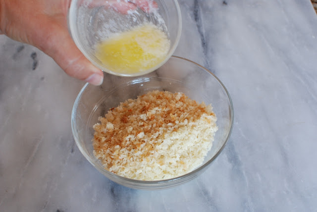 Butter in small bowl over bowl of bread crumbs