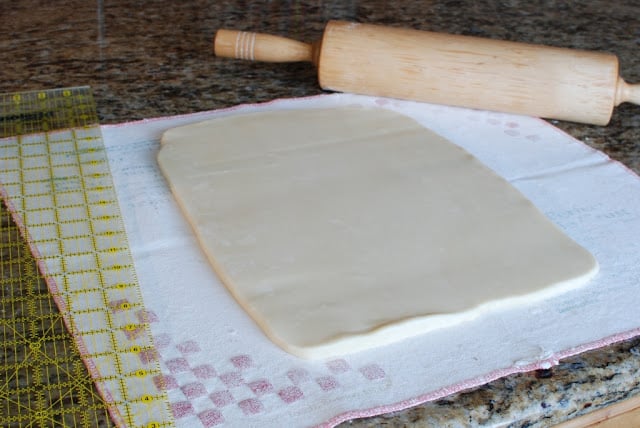 Rolled out shortbread dough with rolling pin