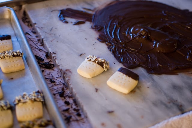 Tempered chocolate on a marble slab with dipped shortbread