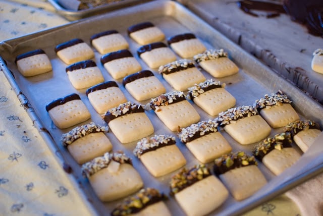 Chocolate dipped edges of shortbread on a baking sheet to dry