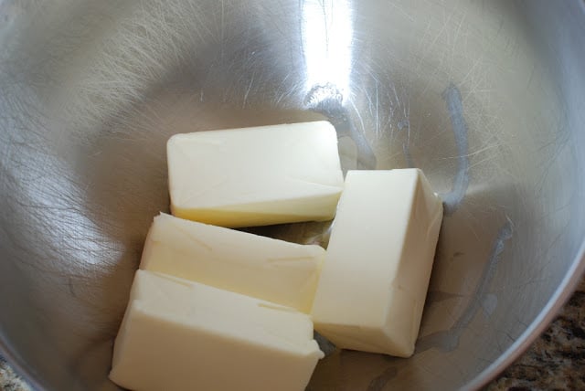 Four cubes of butter in a stainless steel bowl