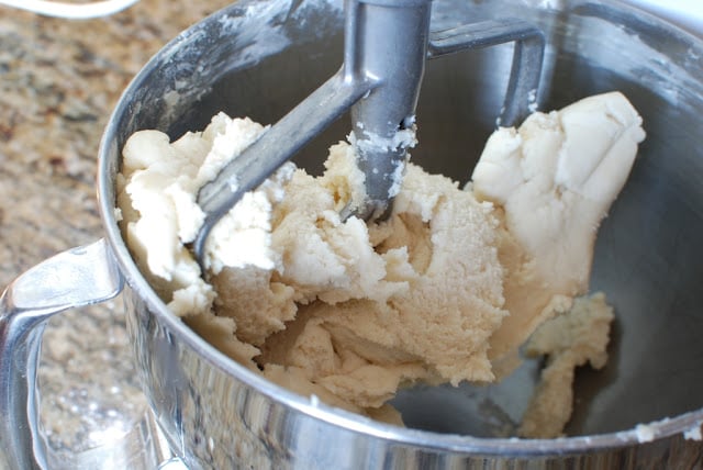 Shortbread dough in a bowl with paddle attachment