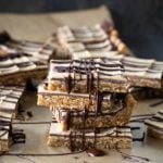 Stacked peanut butter bars with chocolate drizzle