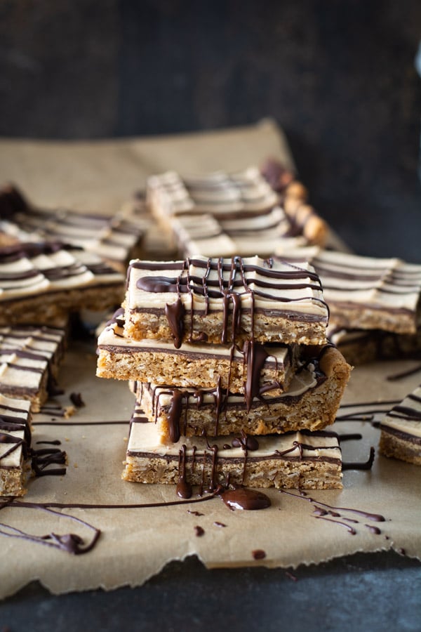 Stacked peanut butter bars with chocolate drizzle