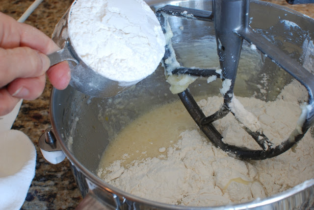 Adding flour to mixing bowl.
