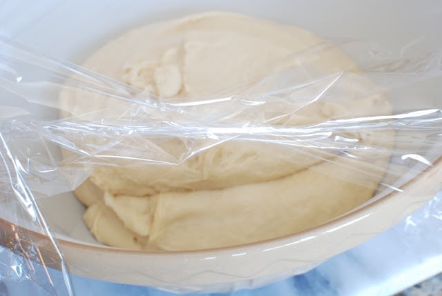 Butterflake dough in a large bowl covered with plastic wrap