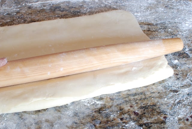 Rolling pin on top of folded dough.