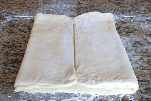 Two folds of dough folded over 1/3 of dough.