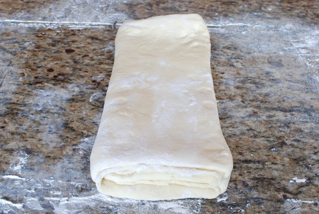 Final folded dough to make orange glazed butterflake rolls.