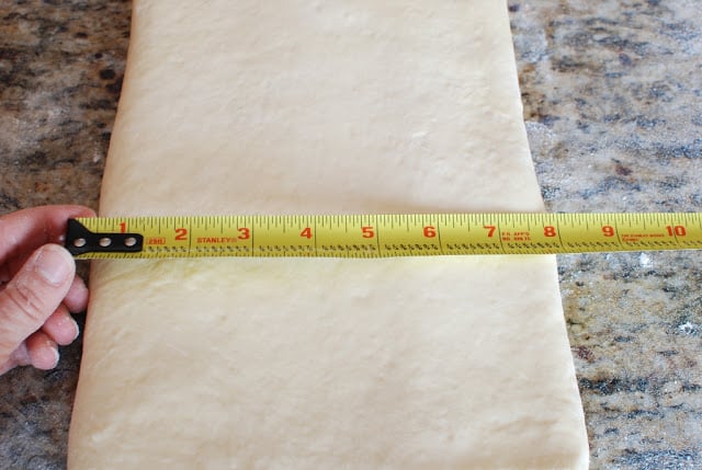 Measuring tape measuring dough.