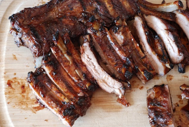 Individually cut ribs on a cutting board.