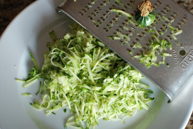 grated zucchini on white plate