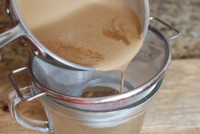 root beer ice cream custard pouring through a strainer