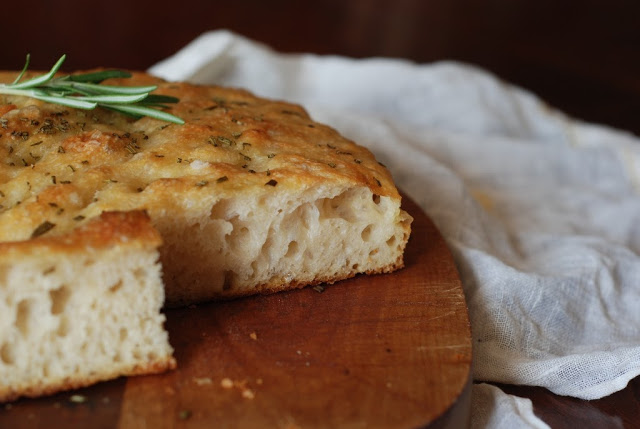 focaccia on cutting board with a sliced
