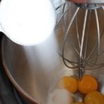 egg yolks in bowl with sugar added