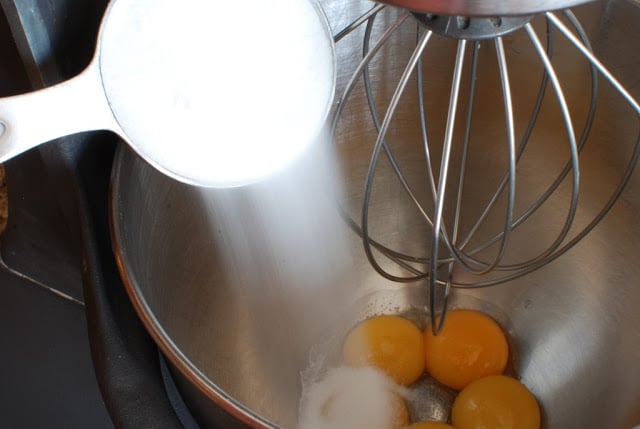 egg yolks in bowl with sugar added