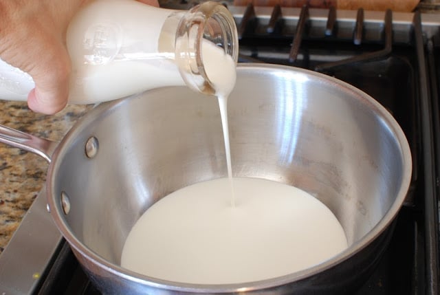 Cream pouring into saucepan
