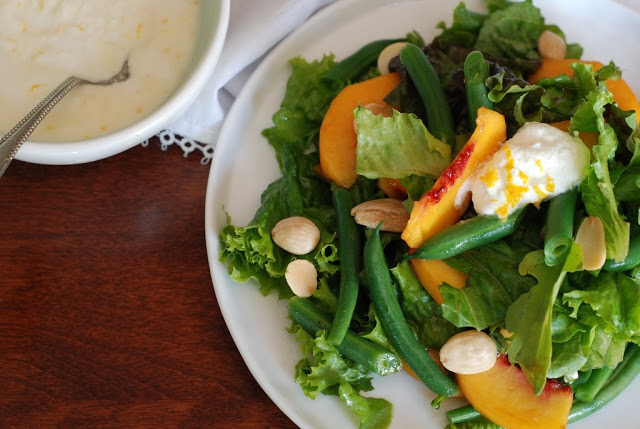 peaches, green beans, almonds, greens, and ricotta on white plate