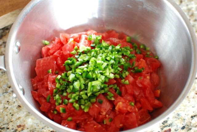 saucepan with chopped tomatoes and jalapeno pepper