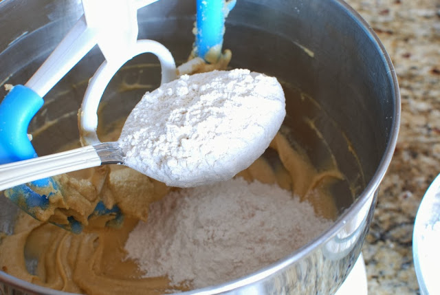 Adding flour to cream cake mixture