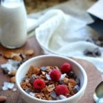 Chocolate granola in a bowl with fresh raspberries