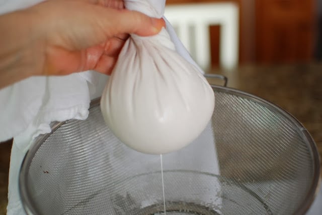 cloth filled with almond pulp with milk streaming though