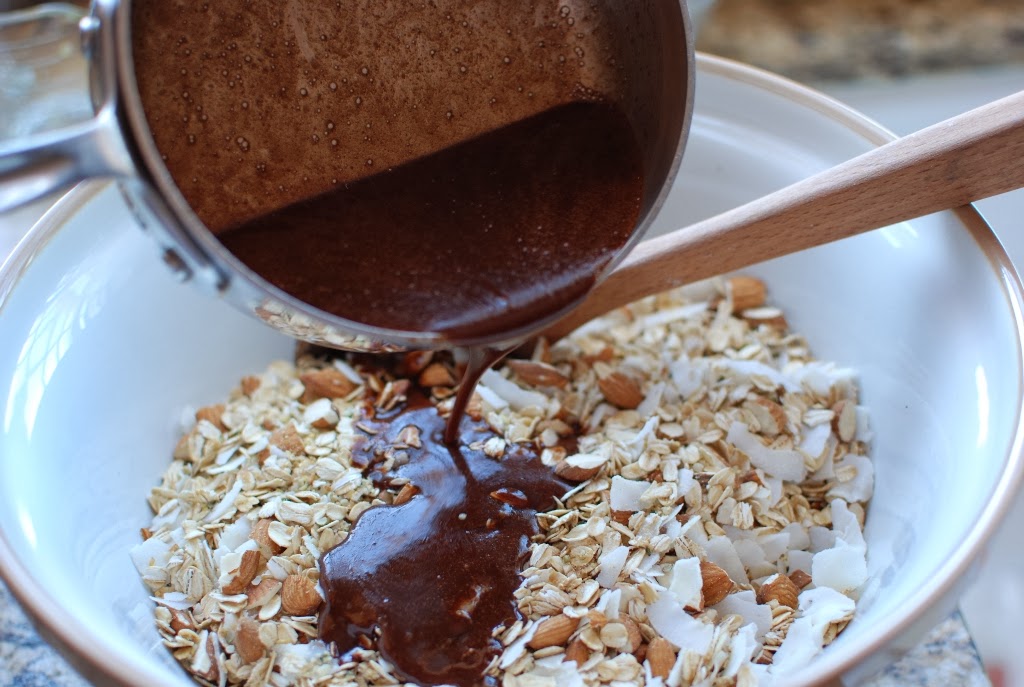 chocolate mixture pouring over oat mixture