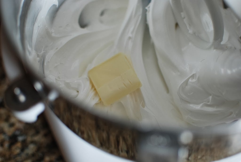 tablespoon of butter on top of meringue in a bowl