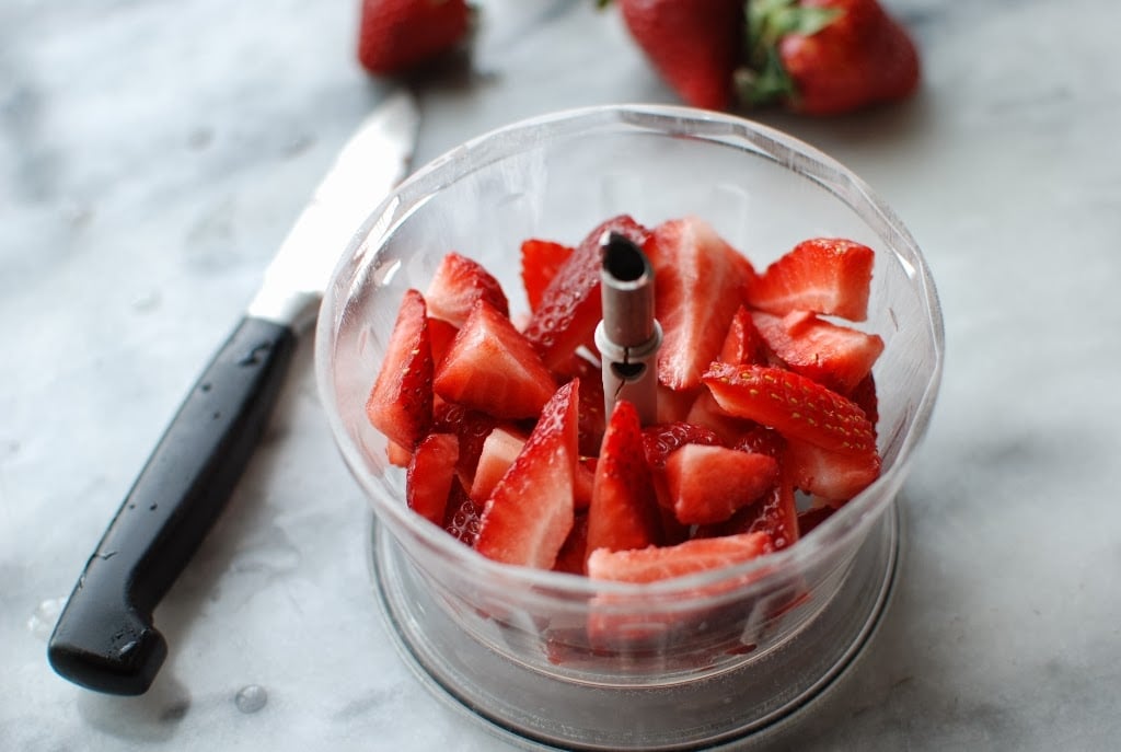 chopped fresh strawberries in bowl of small food processor