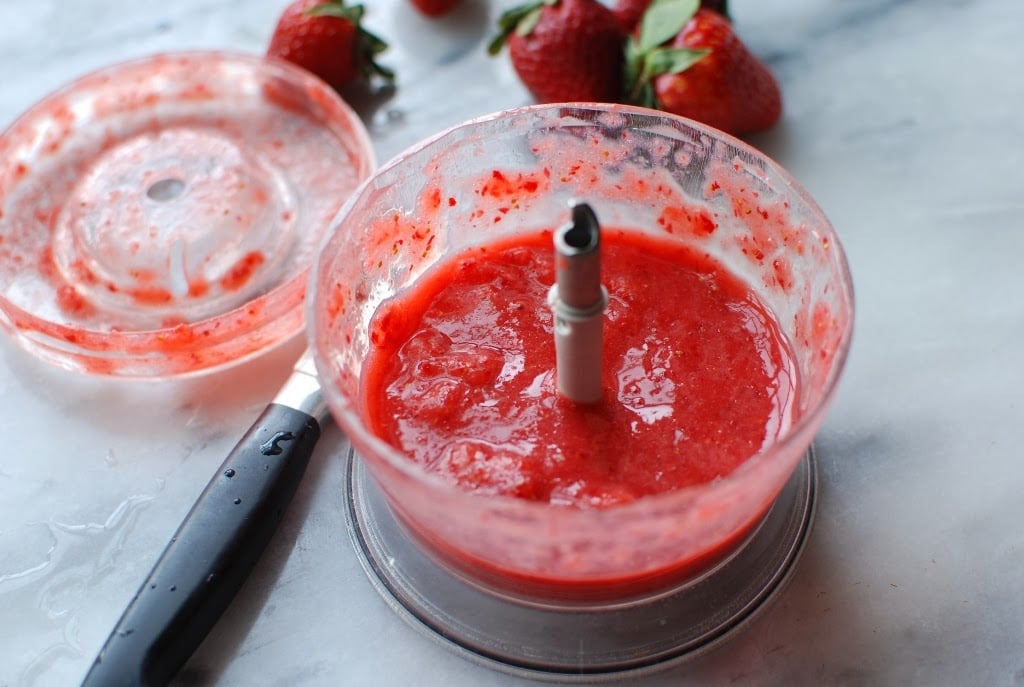 Pureed strawberries in bowl of small food processor