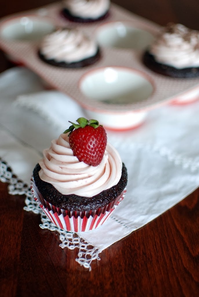 chocolate cupcake with strawberry icing and a red strawberry on top