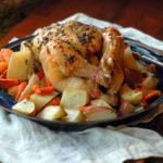 roasted chicken on platter with roasted vegetables