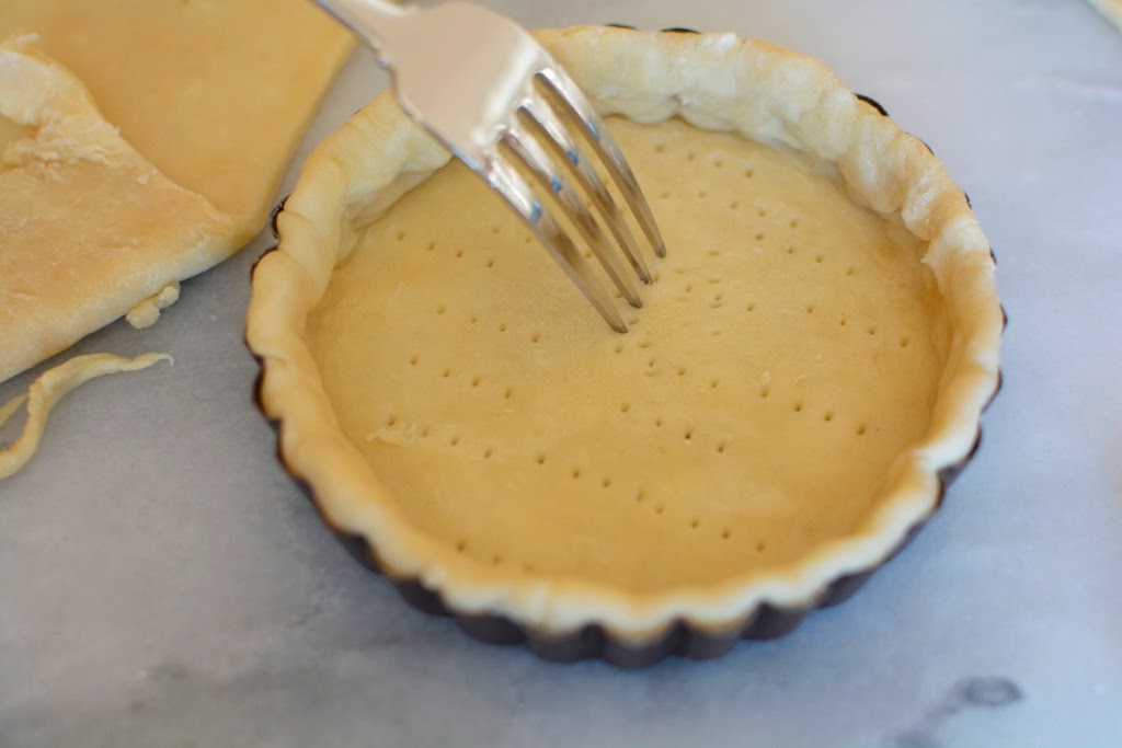 Pricking pie dough with fork