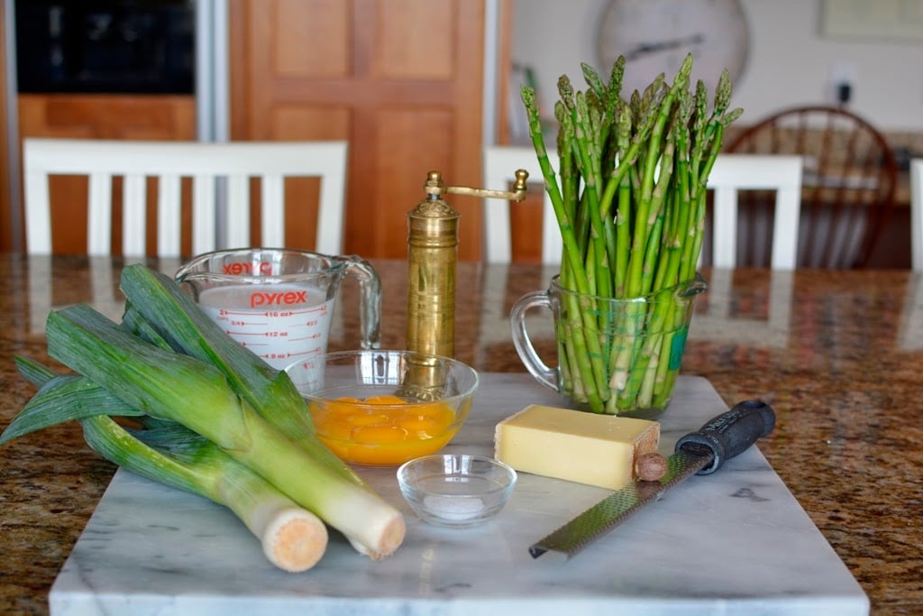 leeks, aparagus, cheese, egg yolks, coconut cream on marble board