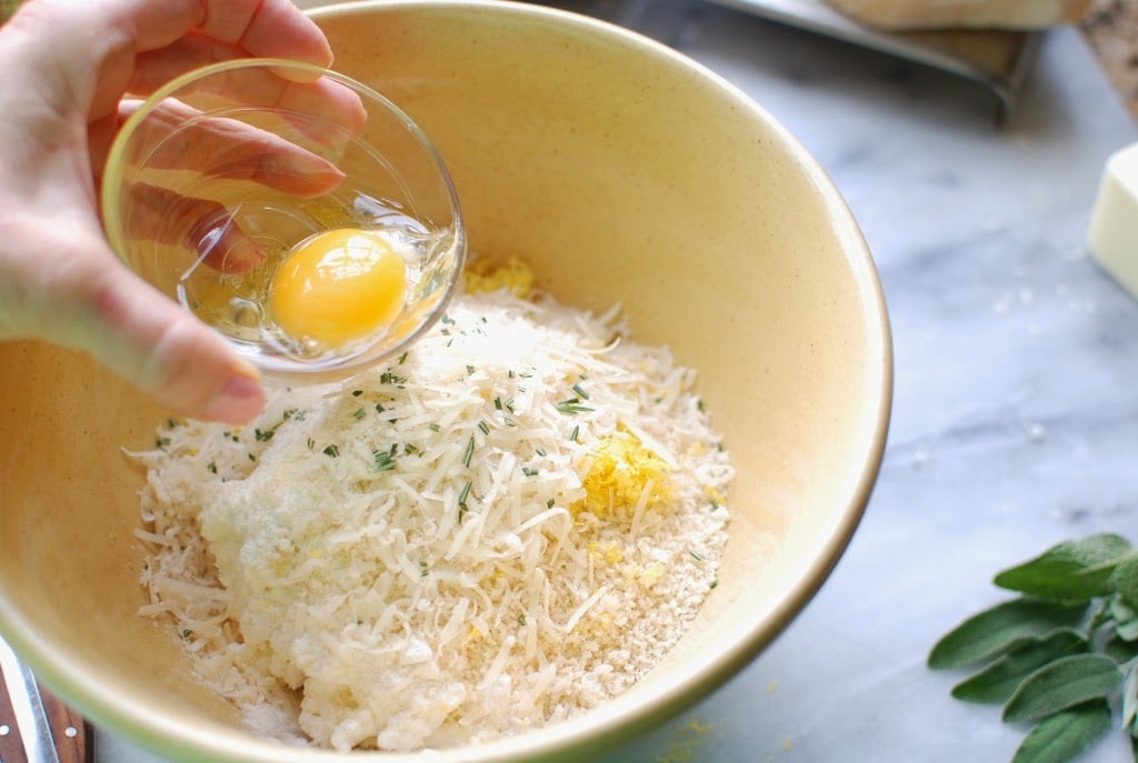 Bowl with ricotta gnocchi ingredients adding egg