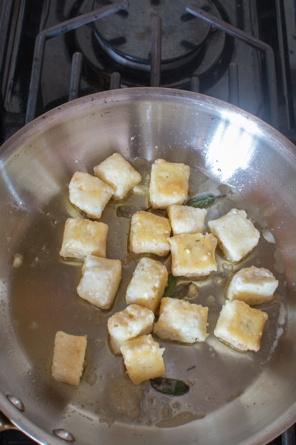 gnocchi in brown butter sauce in skillet