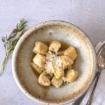 gnocchi in brown butter sauce with parmesan in bowl