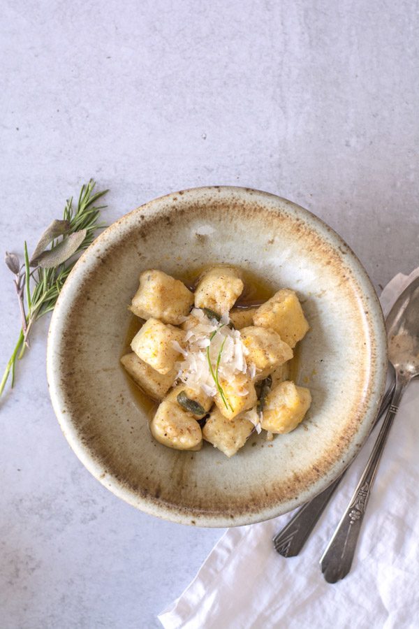 gnocchi in brown butter sauce with parmesan in bowl