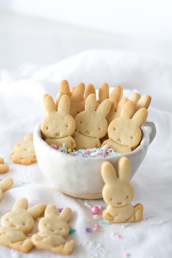 white cup with sprinkles and bunny cookies