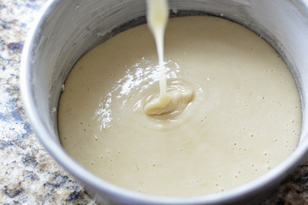 Cake batter pouring into baking pan