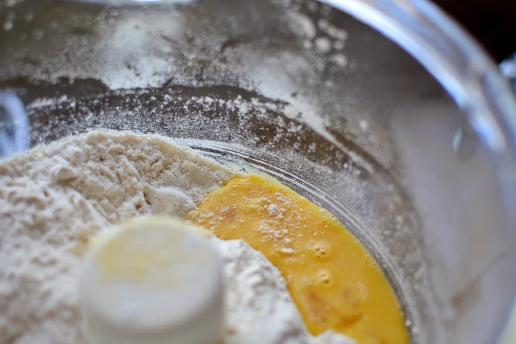 beaten egg and flour in bowl of food processor