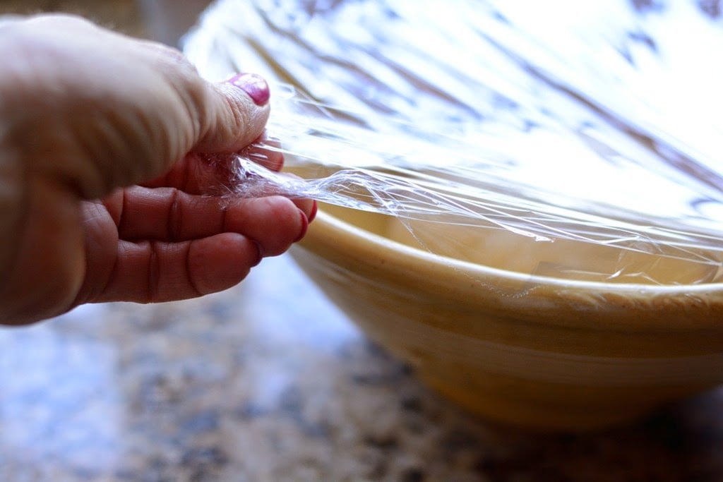 plastic wrap over yellow bowl