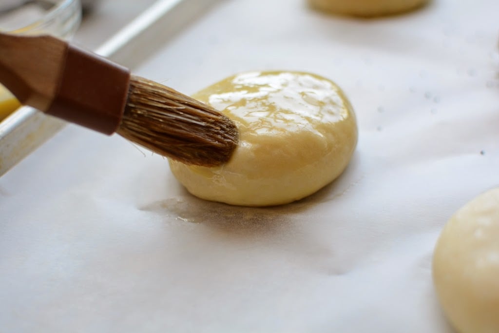 brushing egg wash on dough