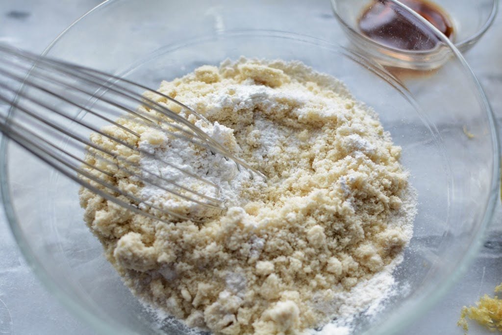 Dry ingredients for cake combined in a glass bowl.