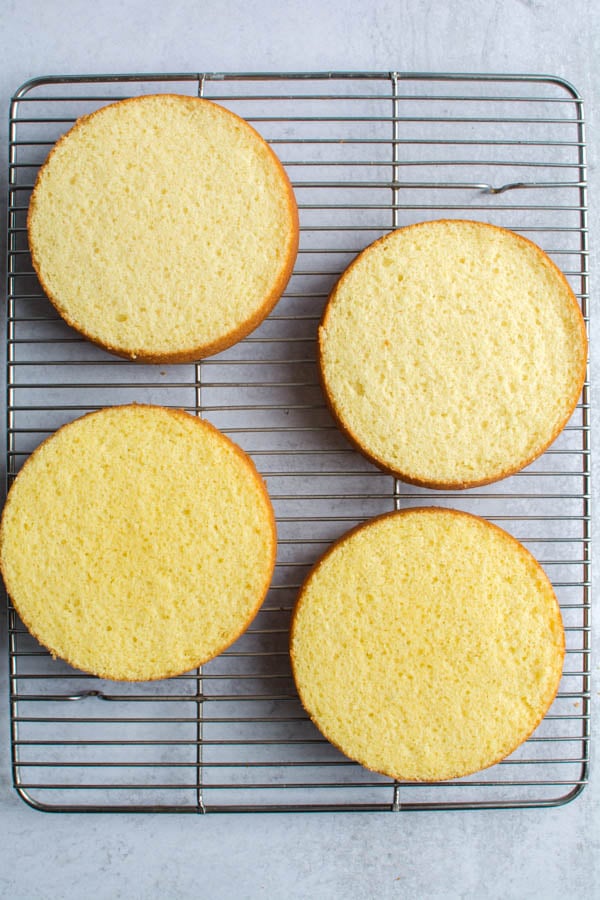 4 cake rounds on cooling rack