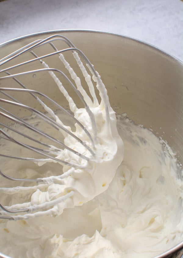 whipped cream in bowl and beater