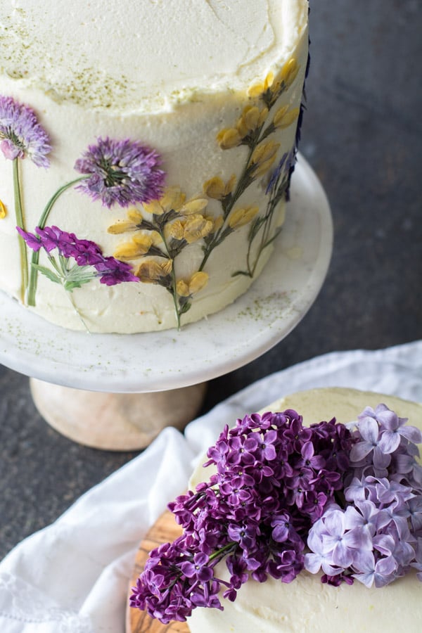 Lemon curd cake with mascarpone frosting and pressed flowers.