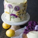 lemons by a lemon olive oil cake with pressed flowers